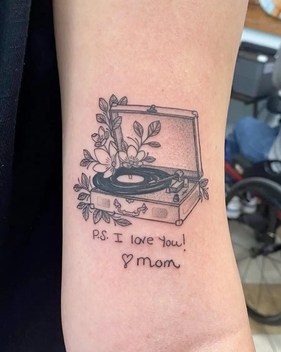 Heartfelt record player tattoo with floral elements