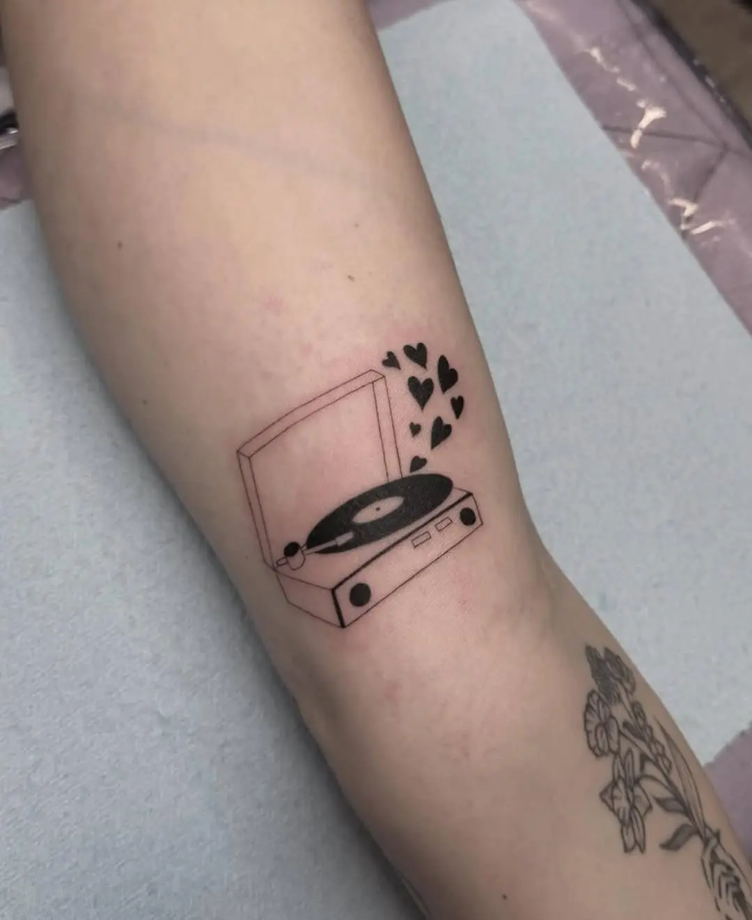 Minimalist record player tattoo with love vibes