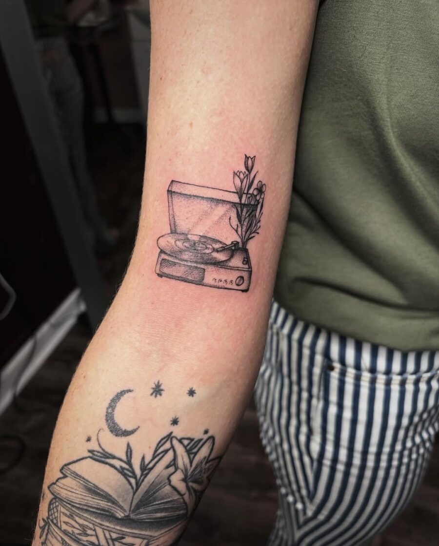 Charming record player tattoo with floral accents