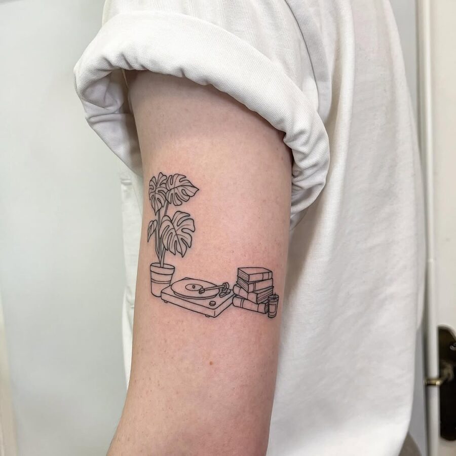 Charming minimalism in record player tattoo