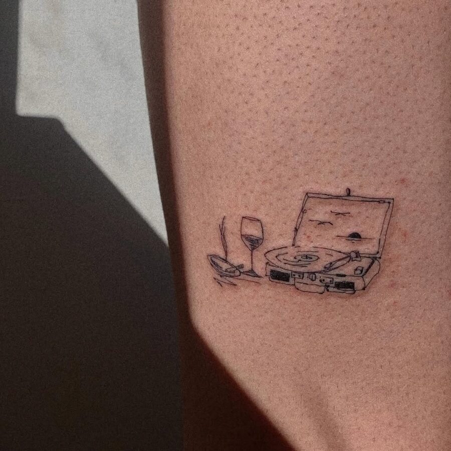 Creative record player tattoo with wine glass