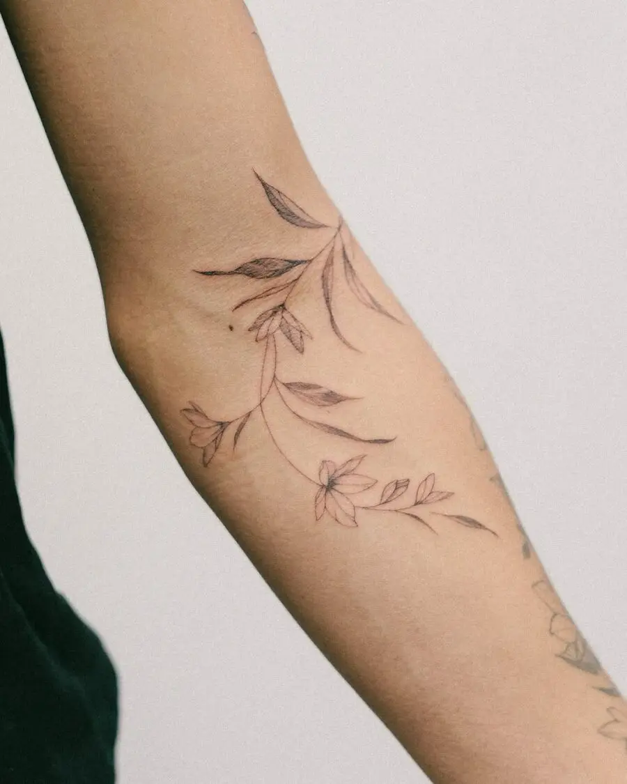 Delicate sampaguita flower tattoo on forearm