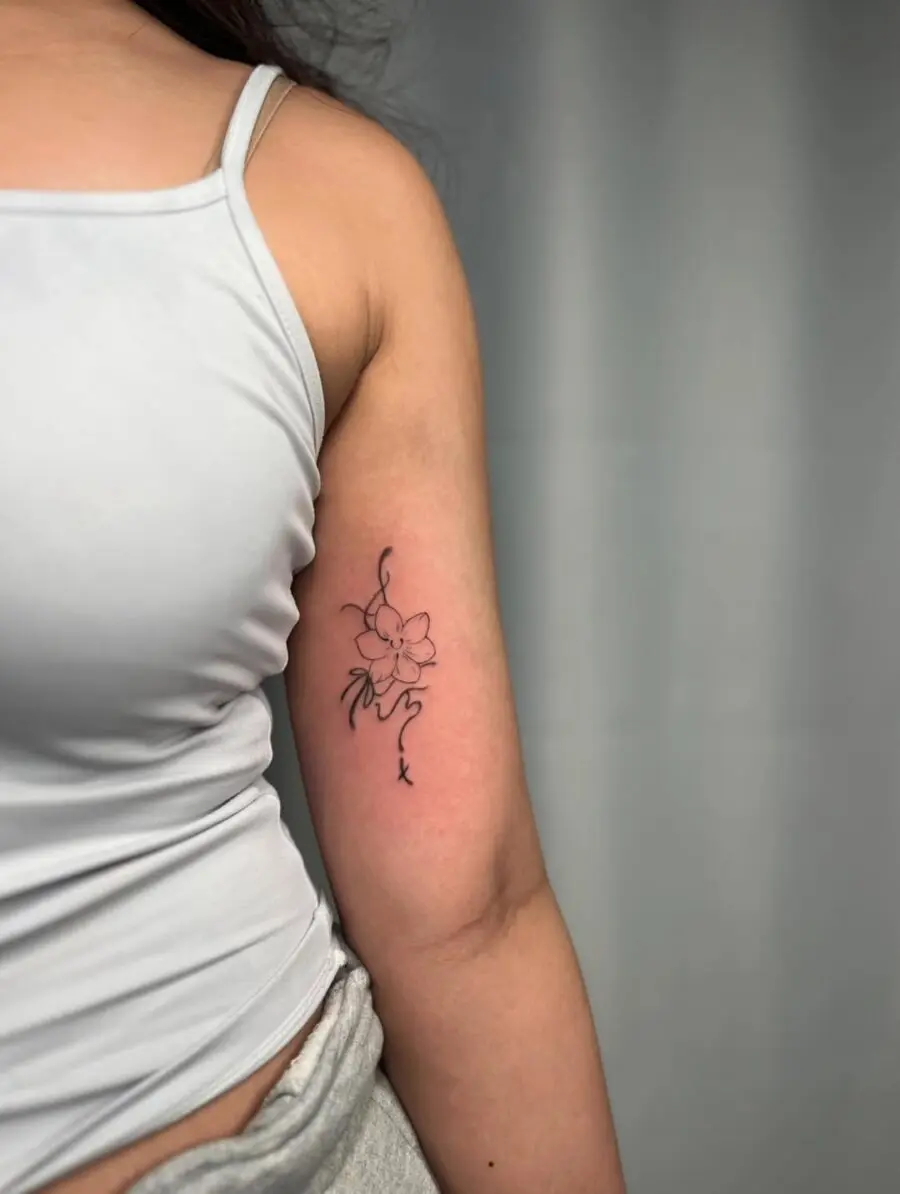Delicate sampaguita tattoo in elegant black ink