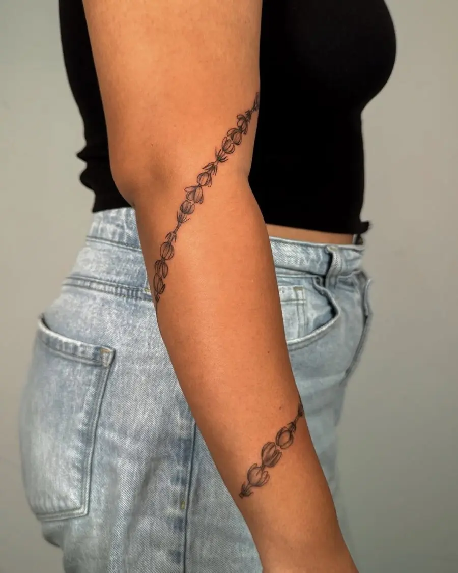 Elegant sampaguita tattoo gracefully wraps around elbow