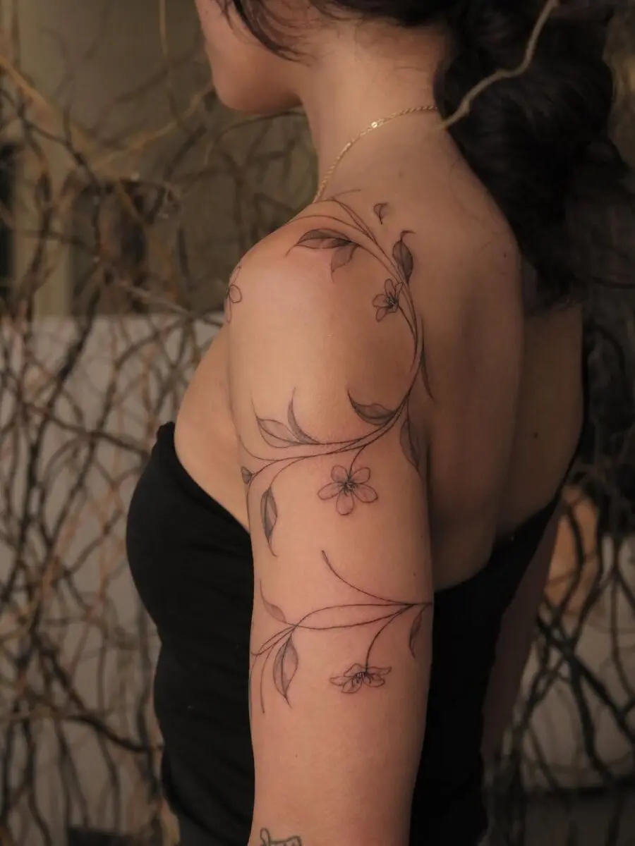 Elegant floral sampaguita tattoo adorns the arm