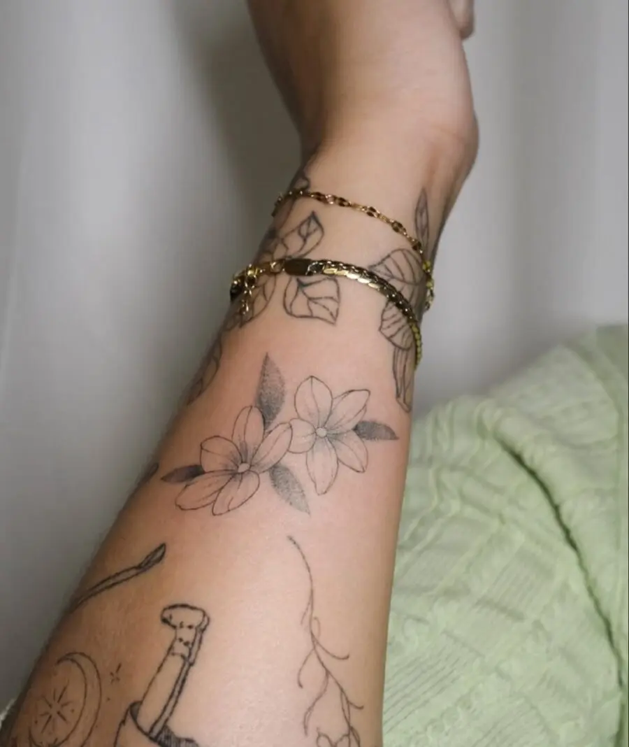 Delicate sampaguita floral tattoo design on arm