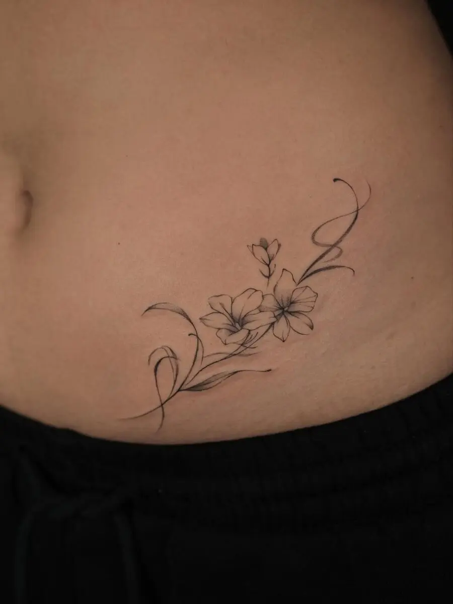 Elegant sampaguita tattoo hugging the body