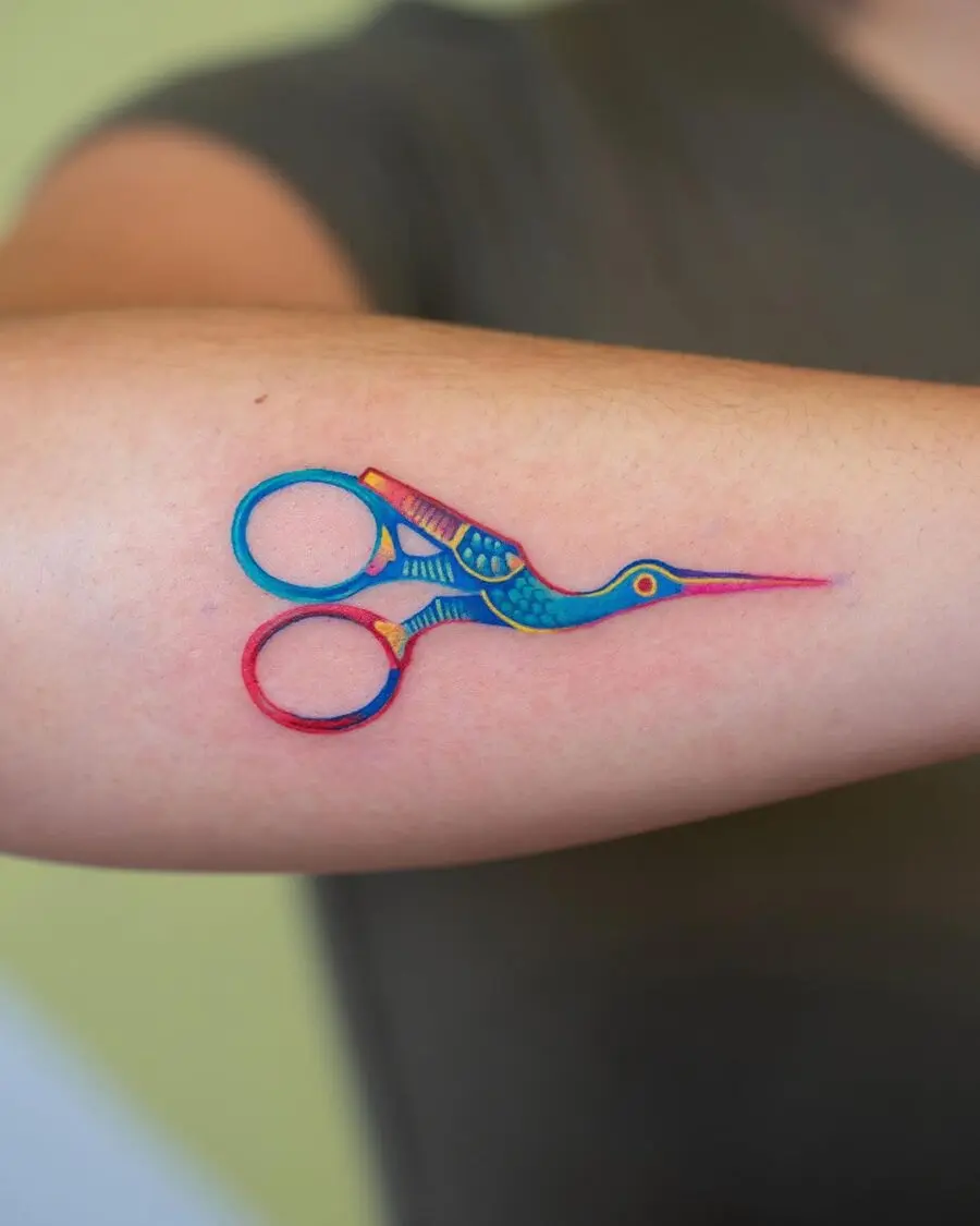Creative bird scissors tattoo on forearm