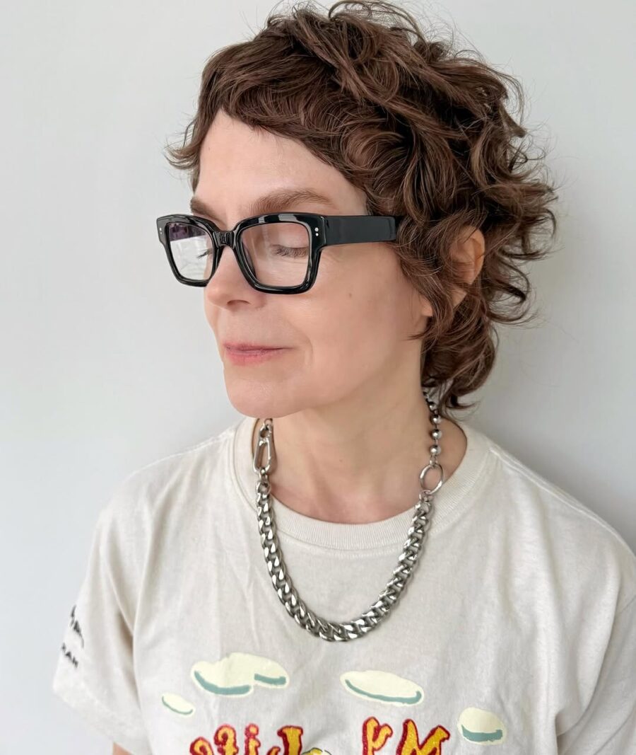 Trendy short curly shag hairstyle with glasses