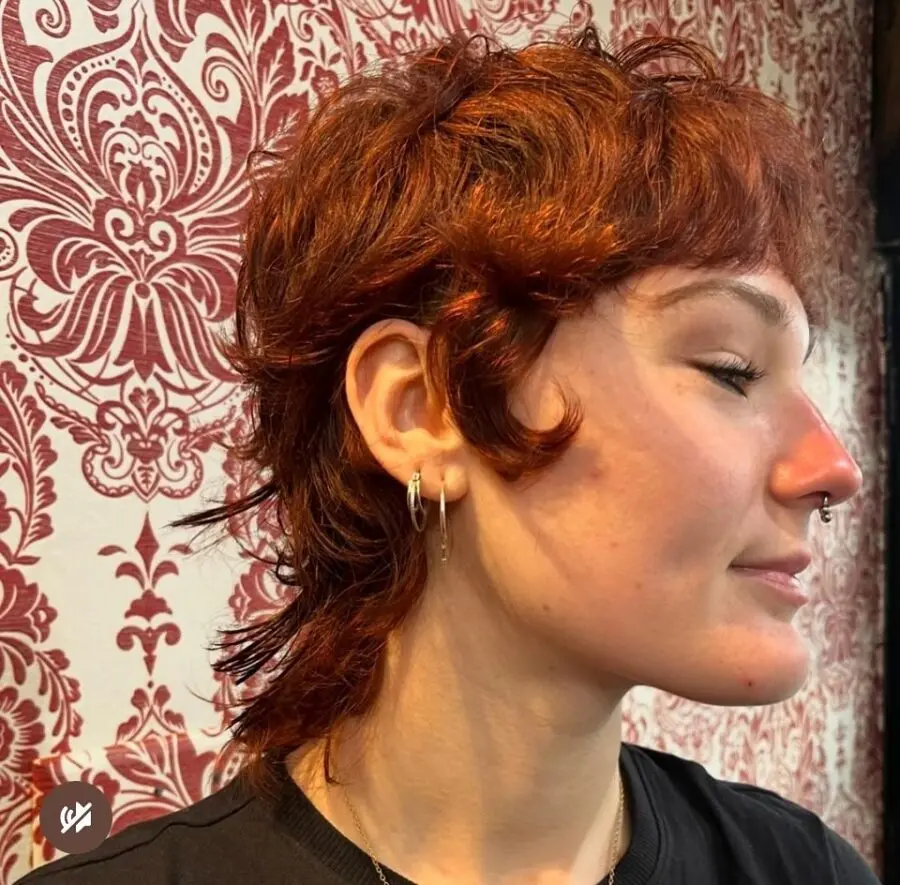Stylish short curly shag with vibrant red hues