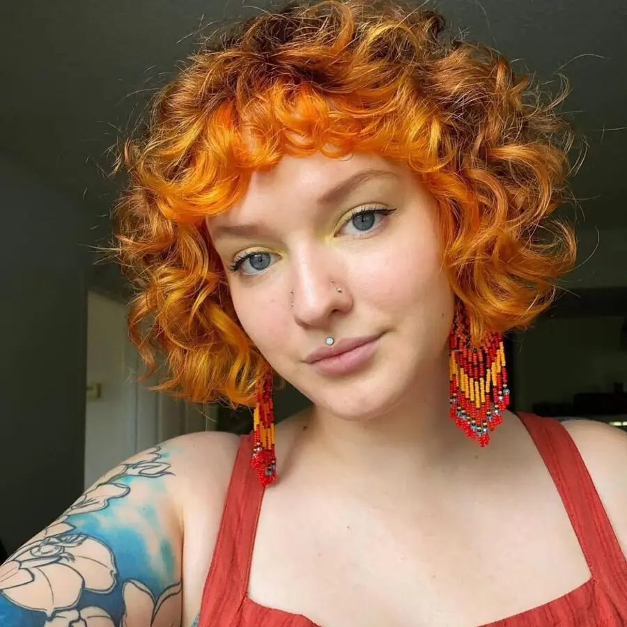 Vibrant orange short curly shag hairstyle