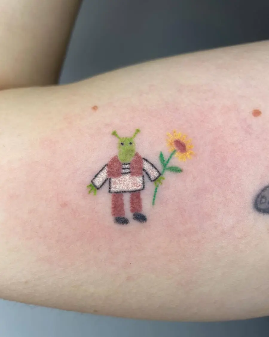 Shrek holding a sunflower tattoo design