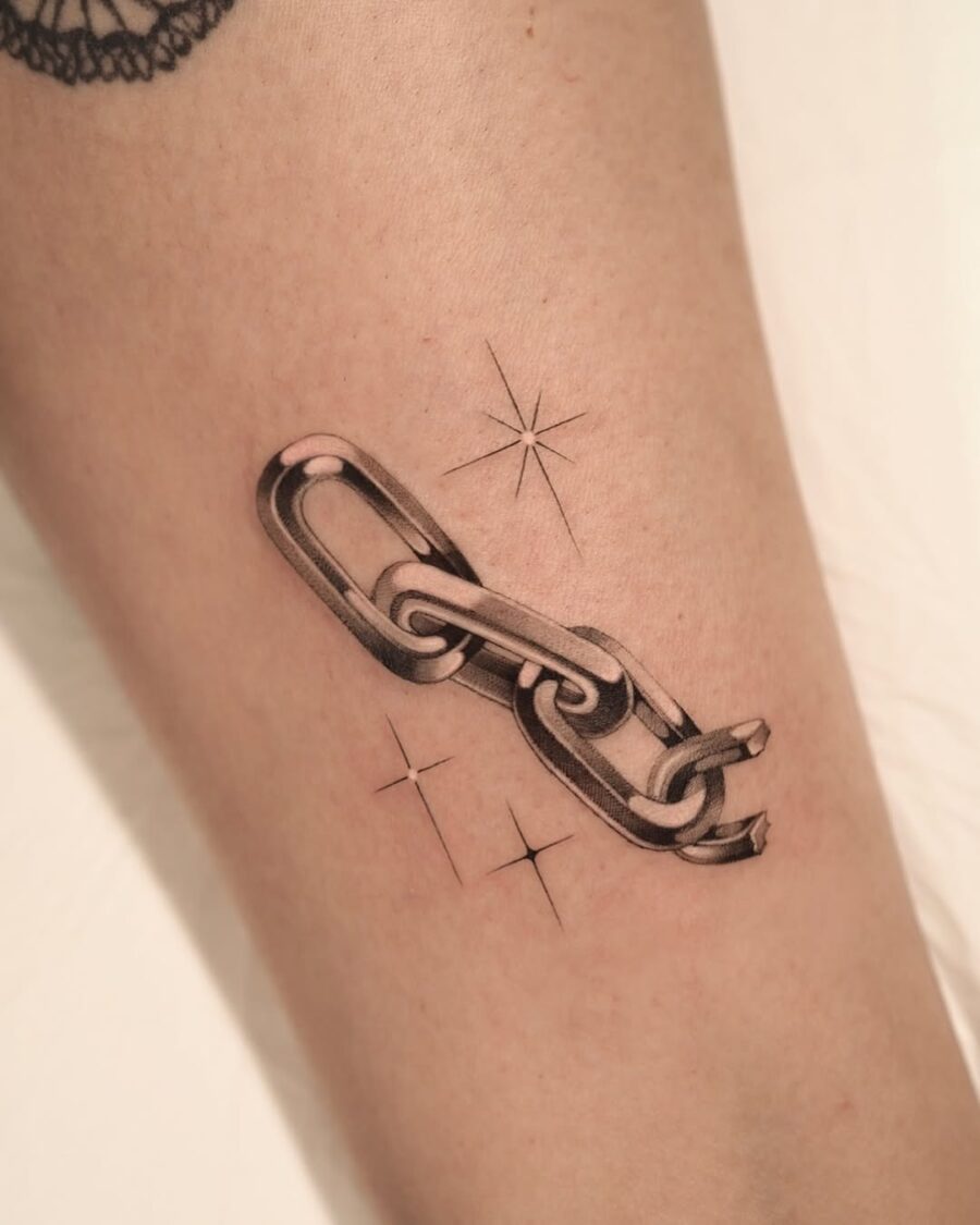Stylish silver chain tattoo with star accents