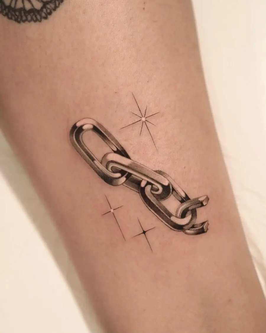 Stylish silver chain tattoo with star accents