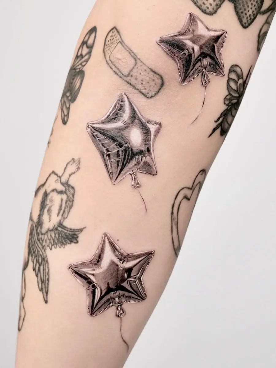 Stylish silver balloon tattoos on the arm