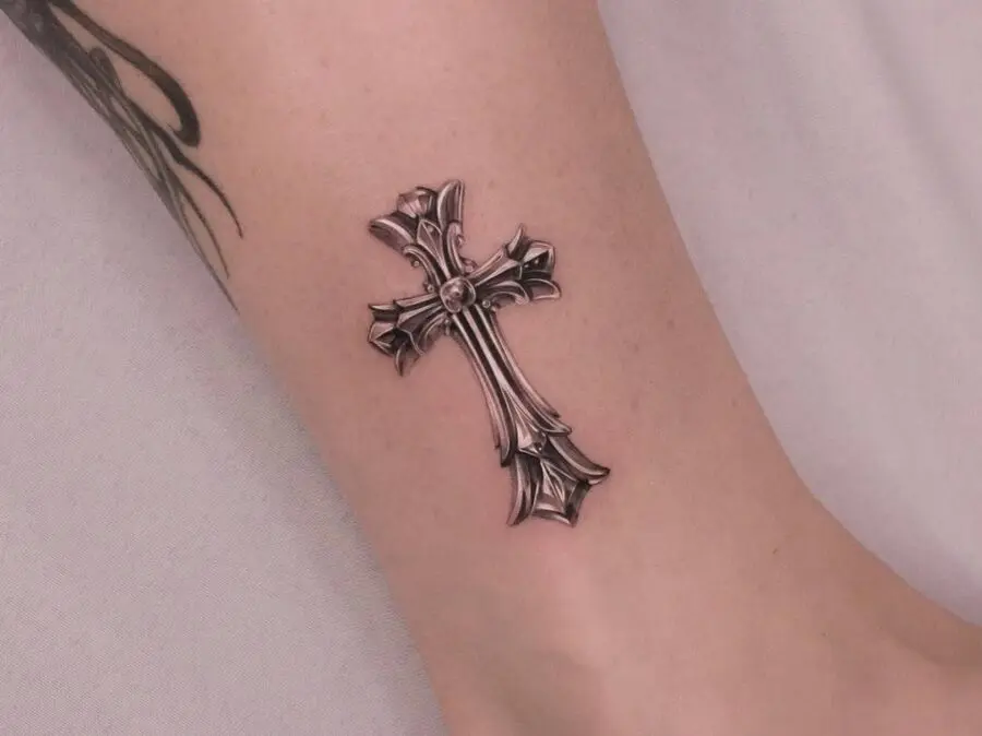 Elegant silver ink cross tattoo on wrist