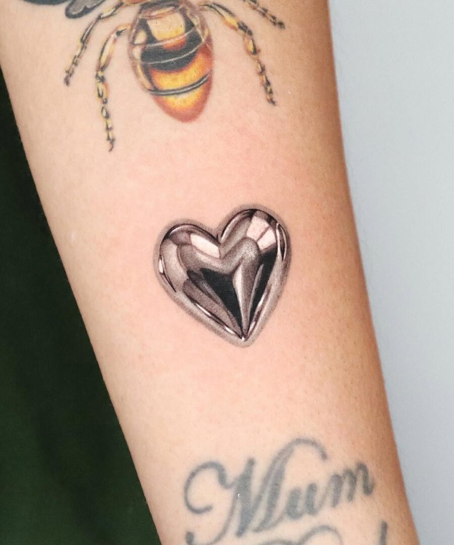 Chic silver heart tattoo design on skin