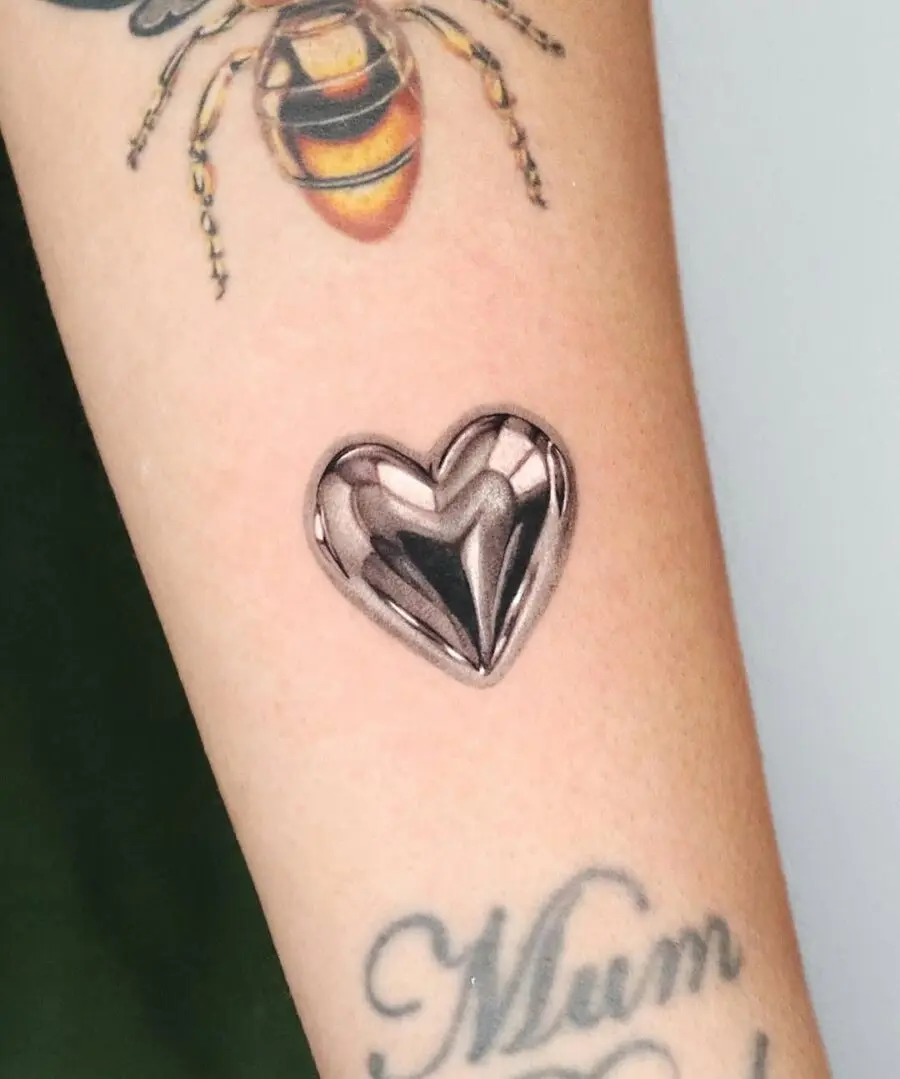 Chic silver heart tattoo design on skin