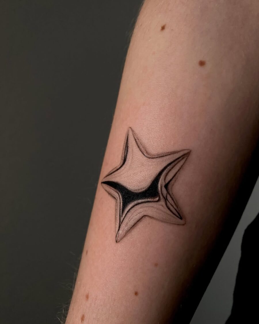 Stunning silver star tattoo on forearm