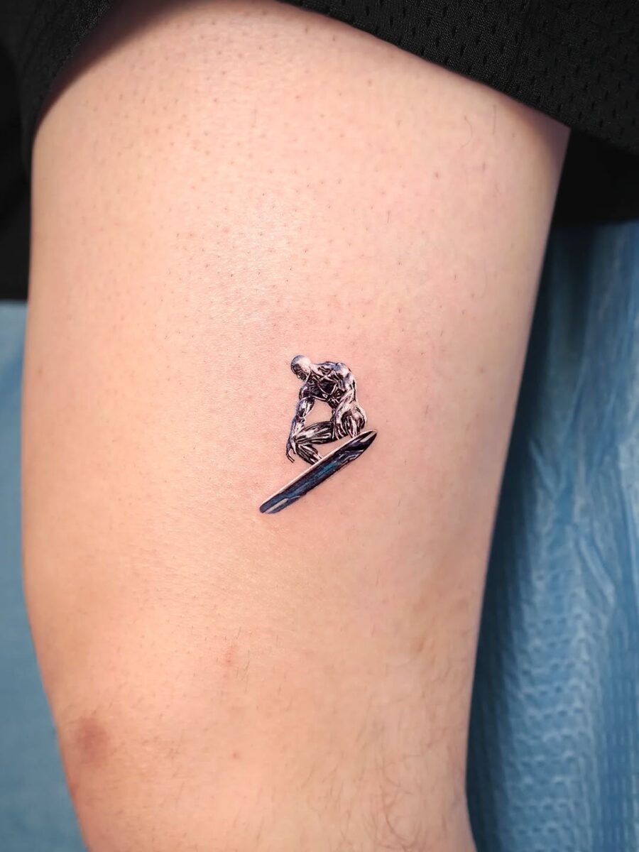 Intricate silver ink surfing skeleton tattoo design