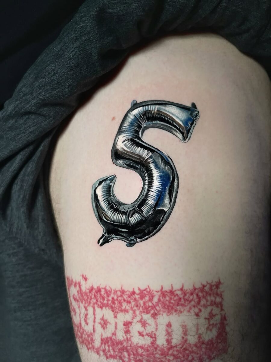Shiny silver ink balloon number tattoo