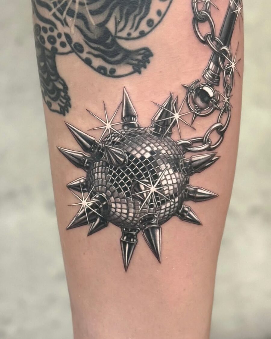 Edgy spiked tattoo with a silver sheen