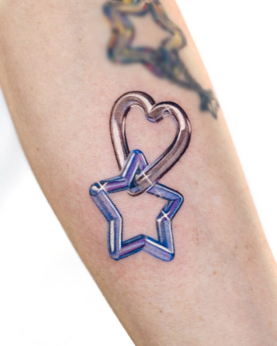 Playful silver ink heart and star tattoo