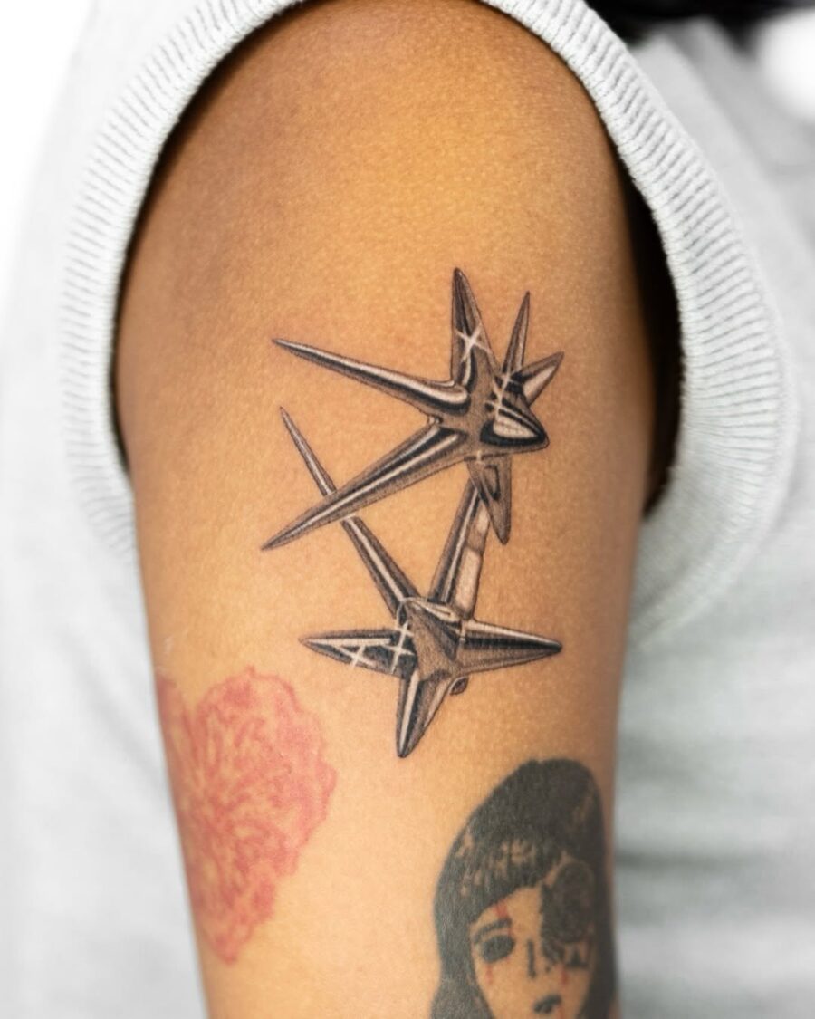 Sharp silver stars tattoo on forearm