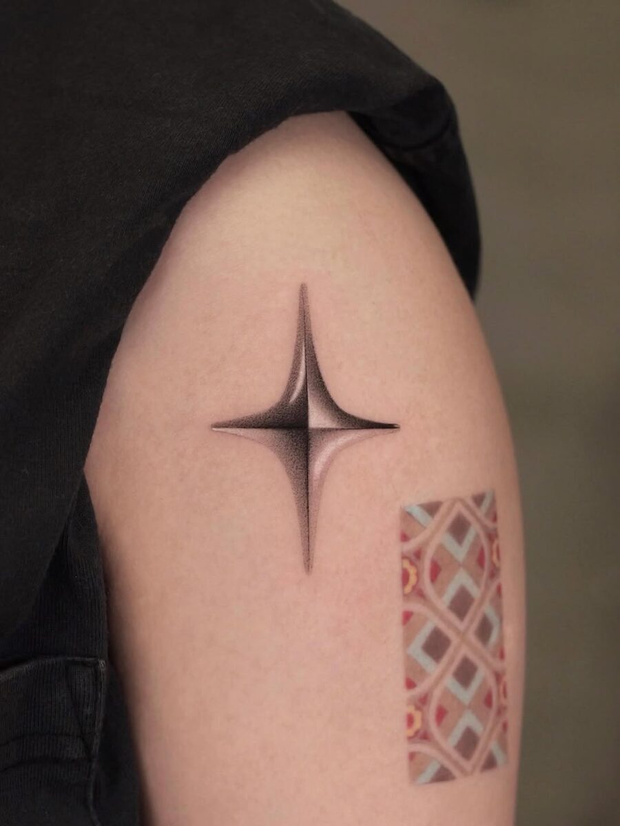 Sleek silver ink star tattoo design