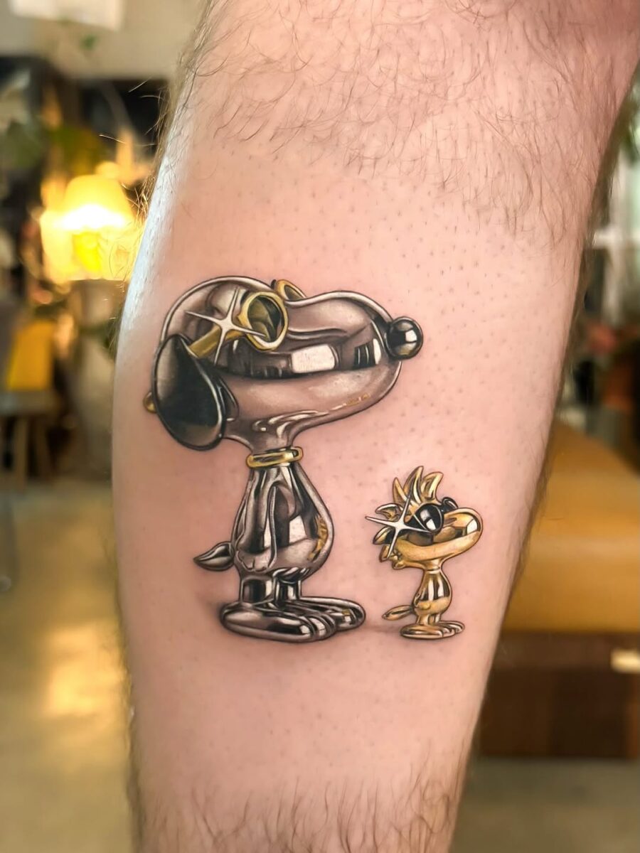 Charming silver ink tattoo of cartoon dog duo