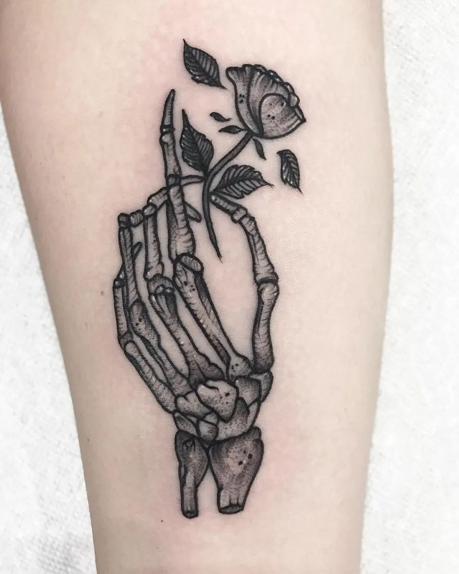 Artful blend of skeleton hand and rose