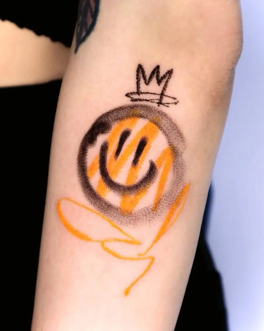 Playful smiley tattoo with a royal twist