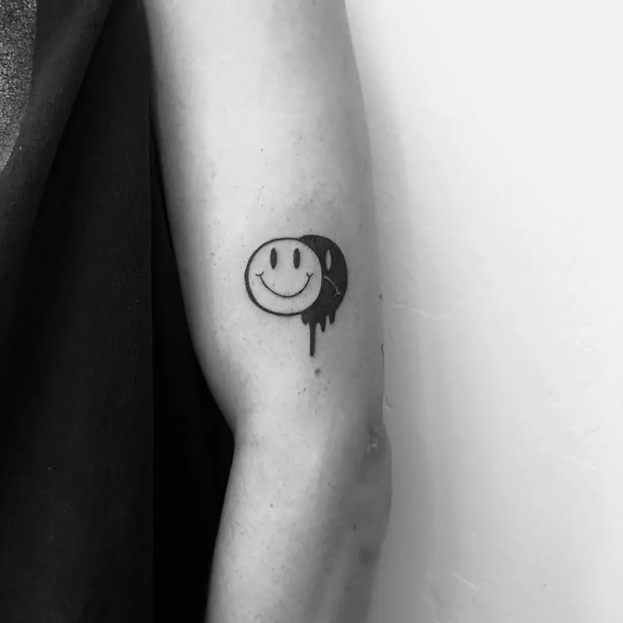 Charming smiley face tattoo with artistic flair