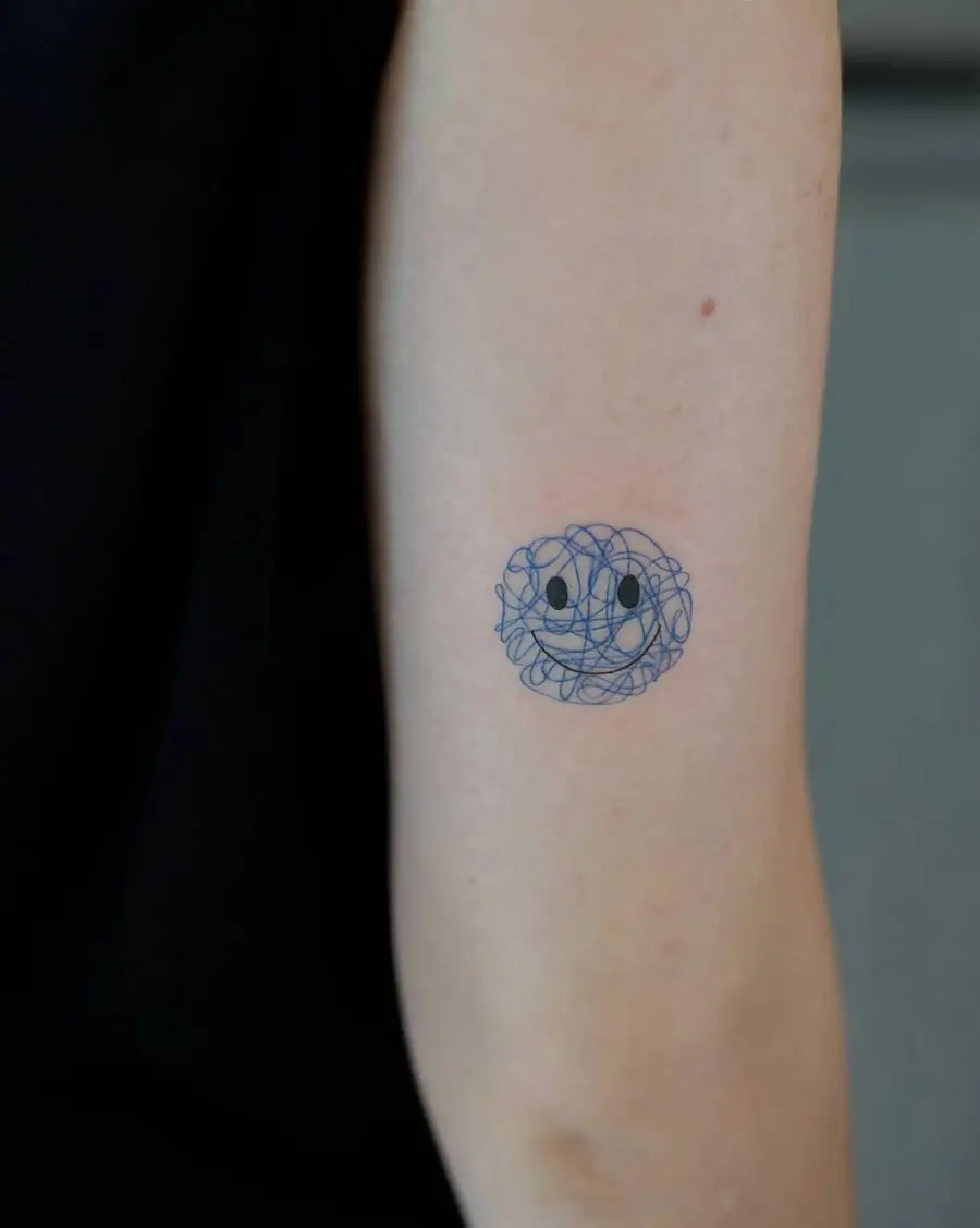 Unique Smiley Face Tattoo with Abstract Swirls