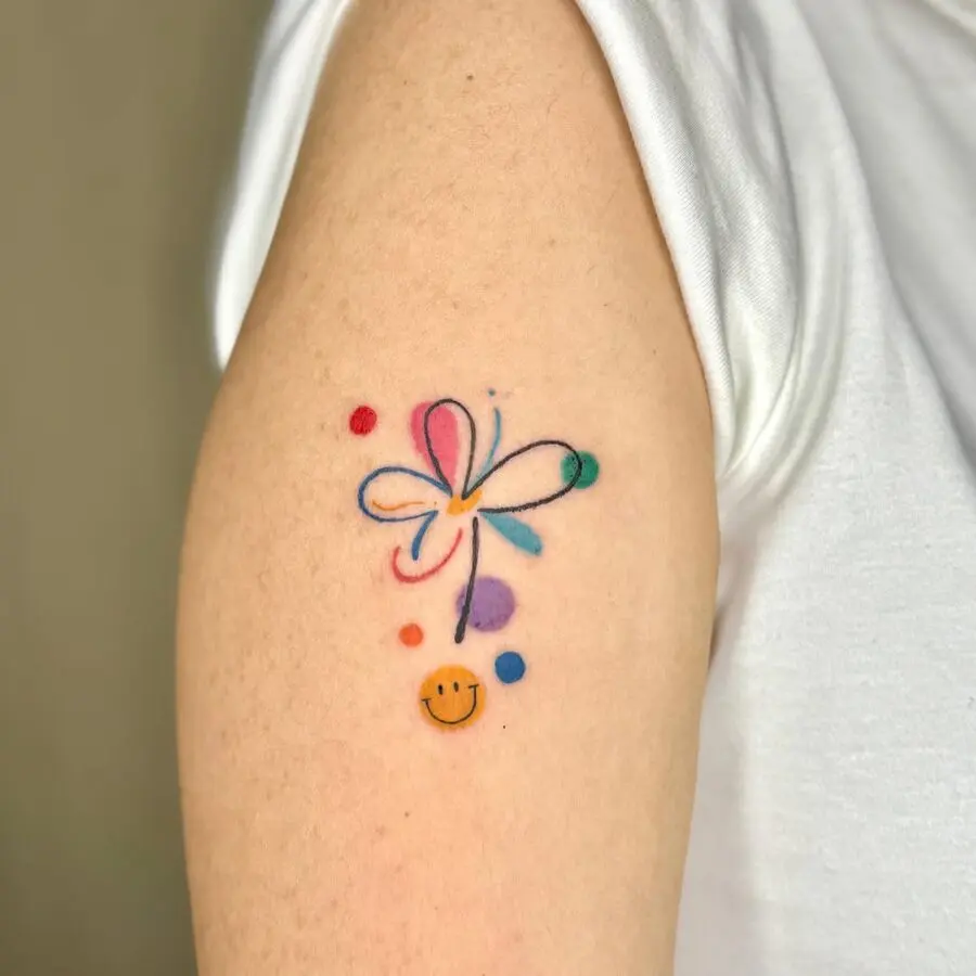 Colorful smiley face tattoo with flower design