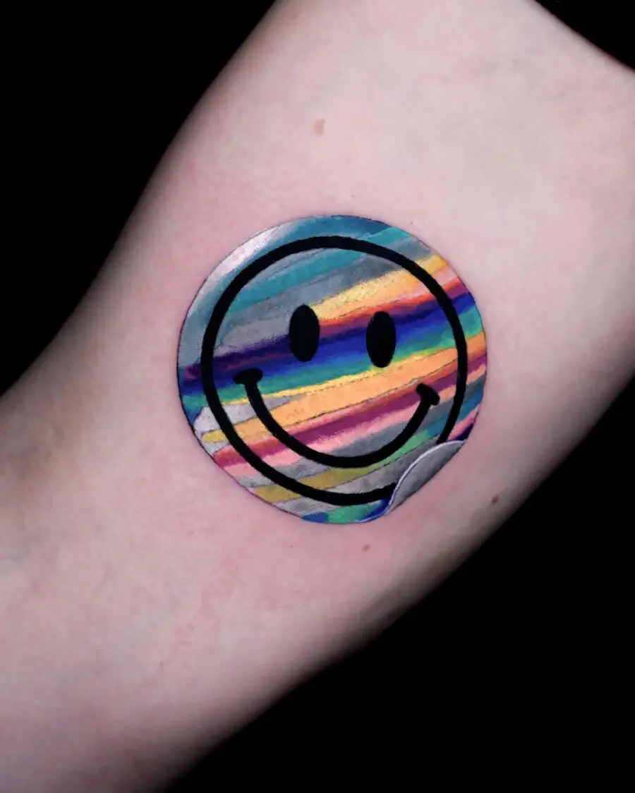 Vibrant smiley face tattoo with playful stripes