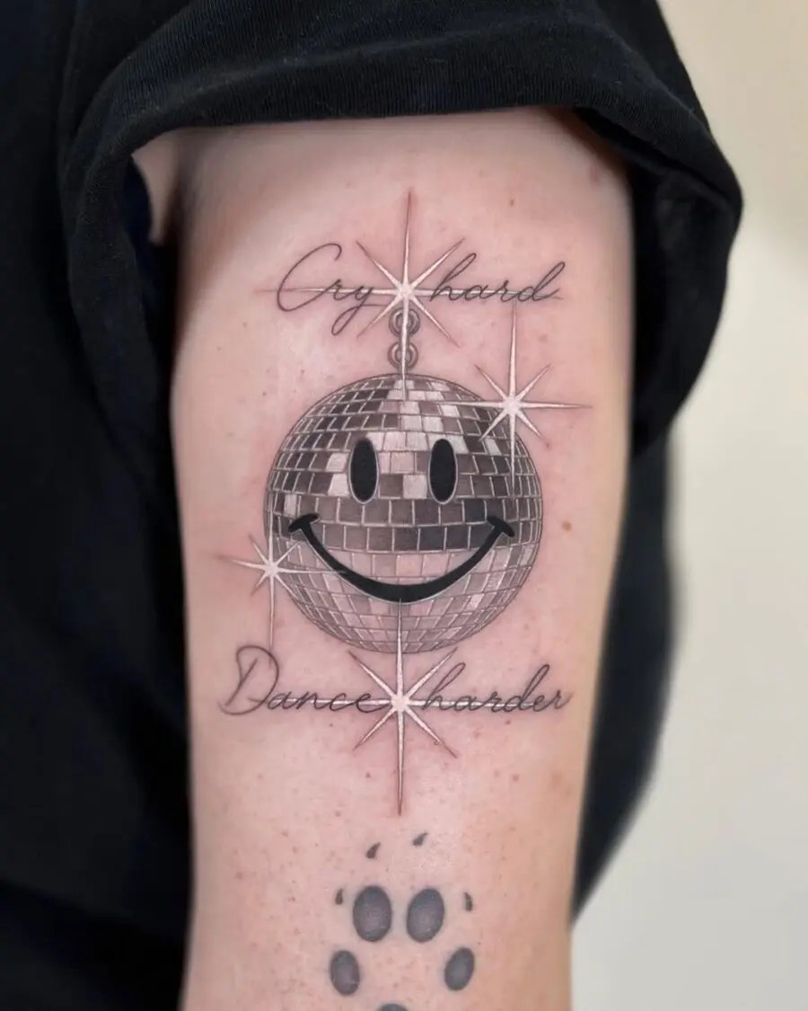 Playful smiley face disco ball tattoo design