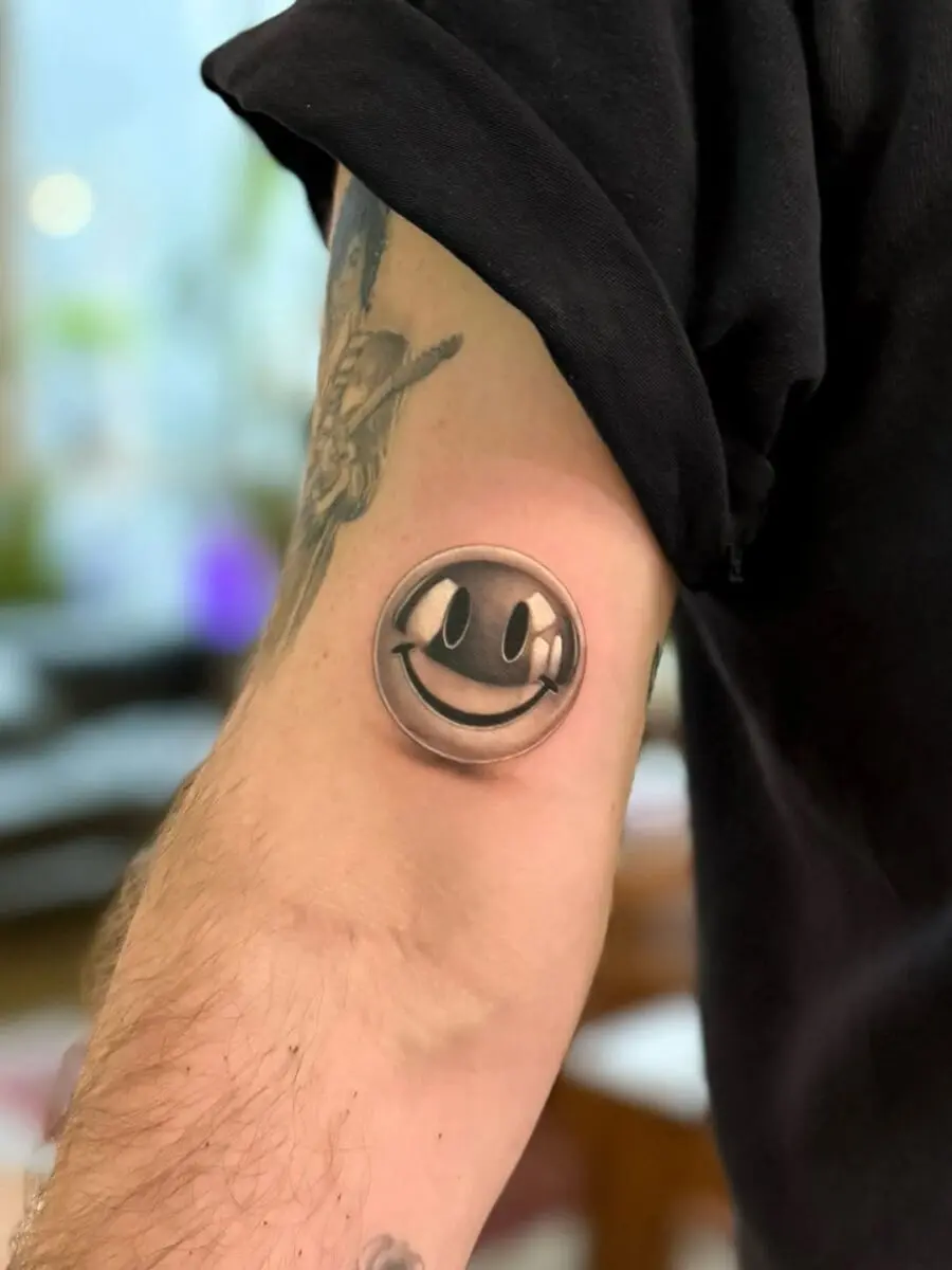 Realistic Smiley Face Tattoo on Arm