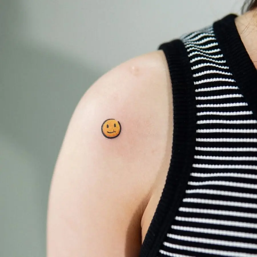 Charming smiley face tattoo on the arm