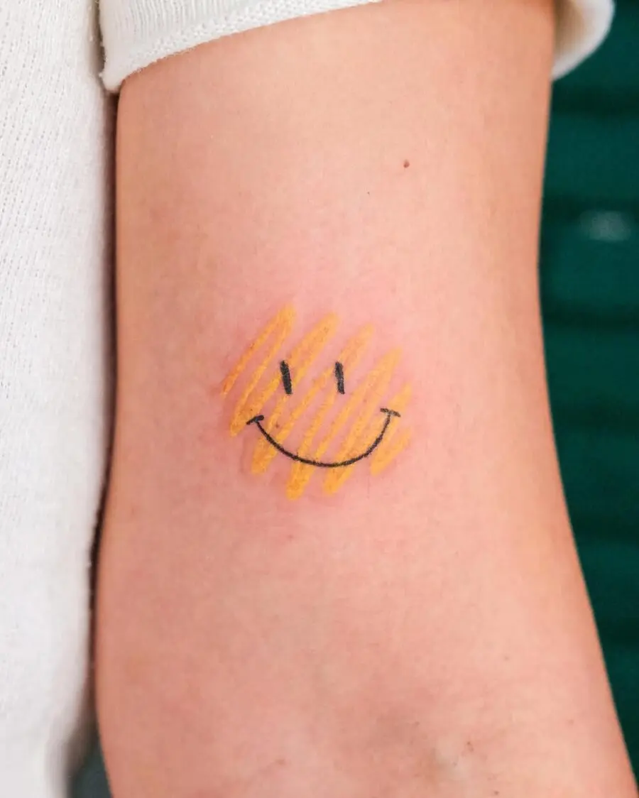 Charming smiley tattoo with warm yellow stripes