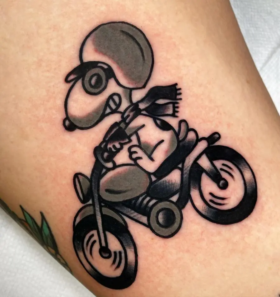 Classic Americana tattoo featuring Snoopy riding