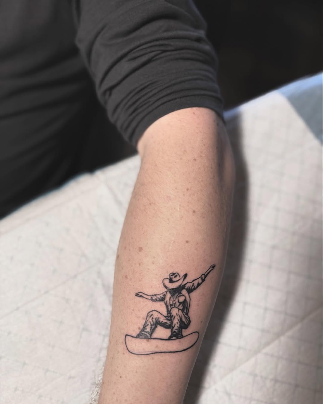 Cowboy-themed snowboard tattoo for adventurous spirits