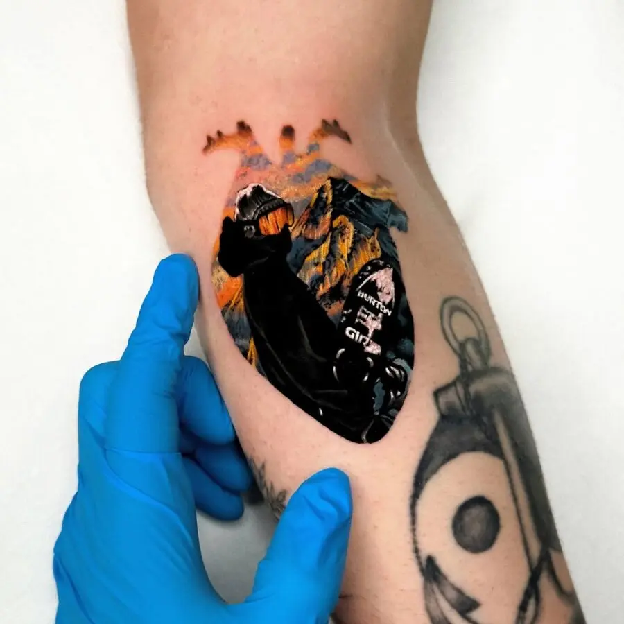 Vibrant snowboarder tattoo with mountain backdrop