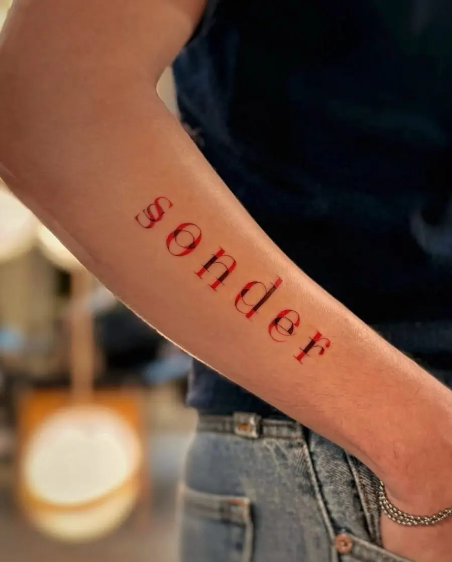 Stunning red font tattoo of 'sonder'