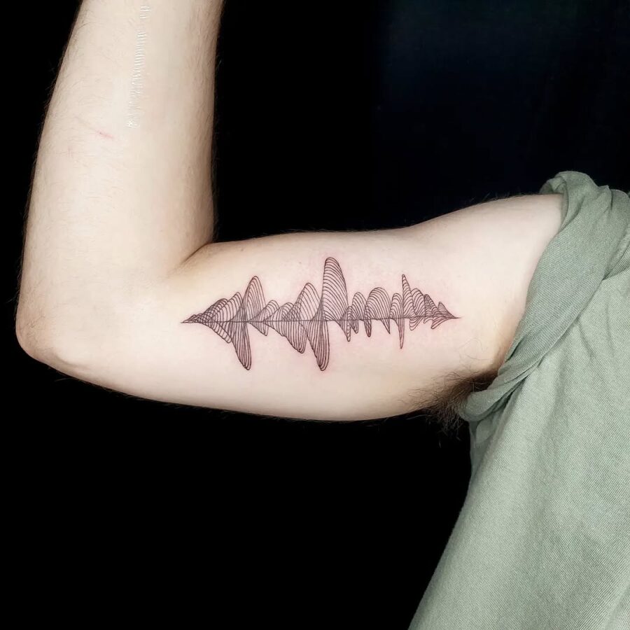 Elegant soundwave tattoo design on the arm