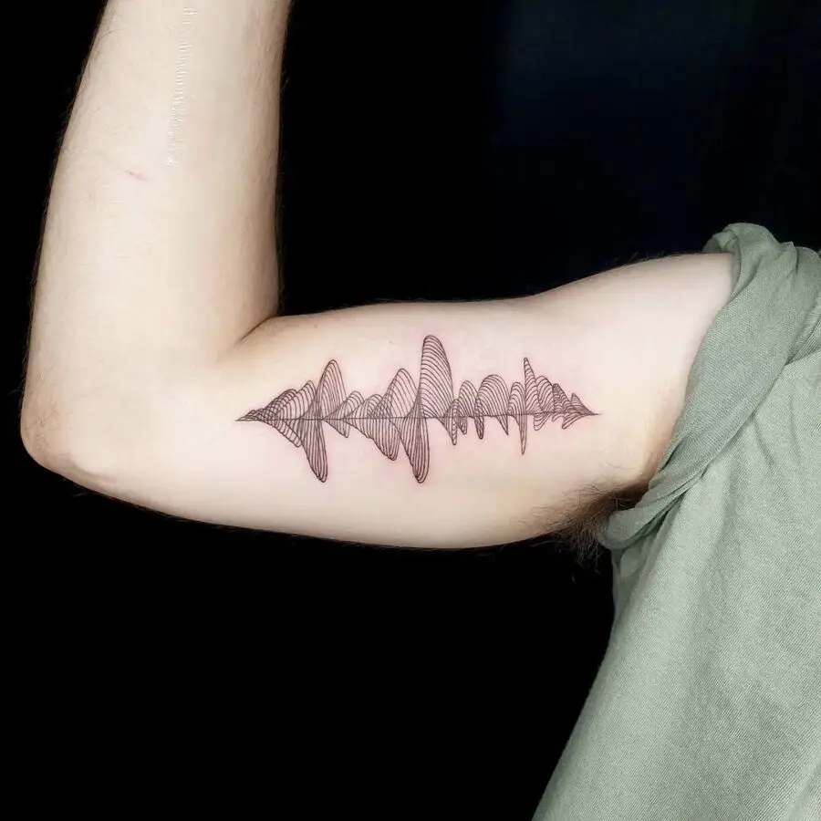 Elegant soundwave tattoo design on the arm