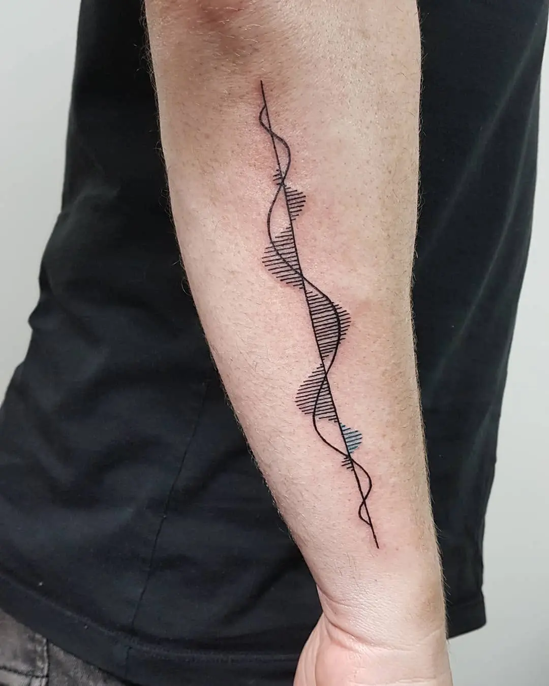 Stylish soundwave tattoo on the forearm