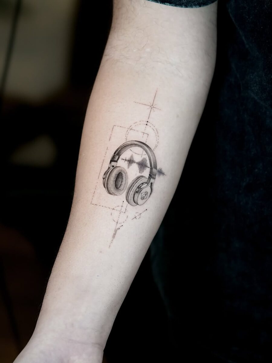 Artistic soundwave tattoo featuring headphones design