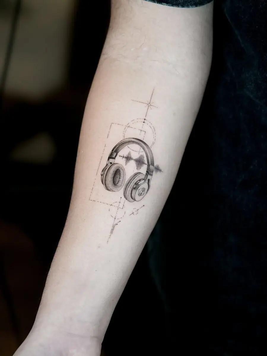 Artistic soundwave tattoo featuring headphones design