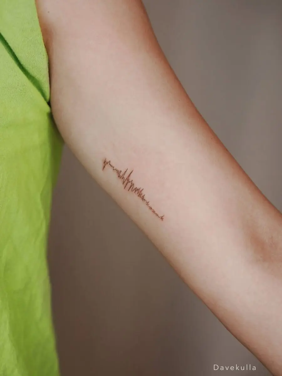 Soundwave tattoo showcasing personal sound design.